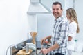 Man helping pregnant woman prepare food Royalty Free Stock Photo