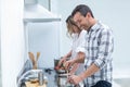 Man helping pregnant woman prepare food Royalty Free Stock Photo