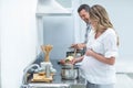 Man helping pregnant woman prepare food Royalty Free Stock Photo