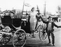 Man helping a woman get out of a wagon Royalty Free Stock Photo