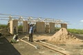 Man helps construct new houses for Pepo La Tumaini Jangwani, HIV/AIDS Community Rehabilitation Program, Orphanage & Clinic. Pepo