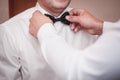 Man helps groom to wear tiebow Royalty Free Stock Photo
