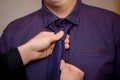 a man helps his friend tie a tie. adjustment of a tie around the neck, a businessman in a shirt. Royalty Free Stock Photo