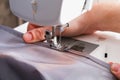 A man hem a curtain on a sewing machine. Sewing, hobbies, hobby, home improvement
