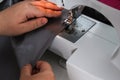 A man hem a curtain on a sewing machine. Sewing, hobbies, hobby, home improvement