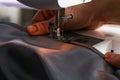 A man hem a curtain on a sewing machine. Sewing, hobbies, hobby, home improvement