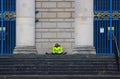 A man in a hi- iz jacket sitting in front of Sheffield City Hall Royalty Free Stock Photo