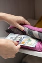 man hides dollars in closet with clothes