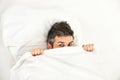 Man with hiding in bed under blanket at home. Royalty Free Stock Photo