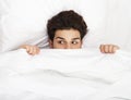 Man hiding in bed Royalty Free Stock Photo