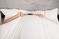 Man hiding in bed under sheets. Royalty Free Stock Photo