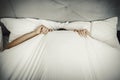 Man hiding in bed under sheets. Royalty Free Stock Photo