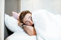 Scared man hiding under the bedsheets Royalty Free Stock Photo