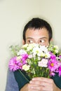 Man hiding behind bouquet Royalty Free Stock Photo