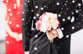 Man hiding bouquet of flowers