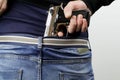 Man is hiding a handgun under the denim belt Royalty Free Stock Photo