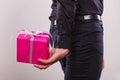 Man hiding pink gift box with ribbon behind back Royalty Free Stock Photo