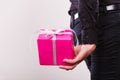 Man hiding pink gift box with ribbon behind back Royalty Free Stock Photo