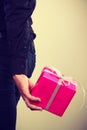 Man hiding pink gift box with ribbon behind back Royalty Free Stock Photo