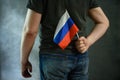 Man hiding Russian flag behind his back