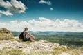 Man Hiker With Backpack Relaxing On Top Of A Mountain