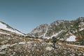 Man hiker with backpack trekking in rocky mountains