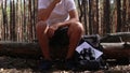 Man hiker drinks tea during a halt in the forest. Concept hike, tourism.