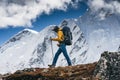 Man hiker going mountain track. Solo traveling with touristick backpack across mountains
