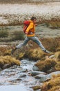 Man hiker jumping over river adventure travel vacation Royalty Free Stock Photo