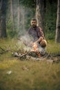 Man hiker make fire in forest Royalty Free Stock Photo