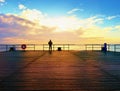 Man hiker on mole at sea. Tourist on wharf looking ower sea to horizon