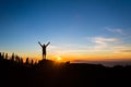 Man hiker silhouette with arms outstretched enjoy mountains