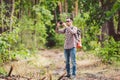 Man hiker taking photo smart phone in forest. Attractive Traveler Making Photo With Mobile Phone. Traveler hiker man Royalty Free Stock Photo