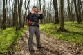 Man hiker taking photo with smart phone in forest Royalty Free Stock Photo