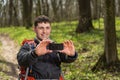 Man hiker taking photo with smart phone in forest Royalty Free Stock Photo