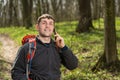 Man hiker taking photo with smart phone in forest Royalty Free Stock Photo