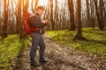 Man hiker taking photo with smart phone in forest Royalty Free Stock Photo