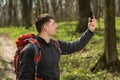 Man hiker taking photo with smart phone in forest Royalty Free Stock Photo