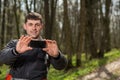 Man hiker taking photo with smart phone in forest Royalty Free Stock Photo