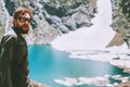 Man hiker traveling at blue lake in mountains