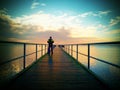 Man hiker walk on wet mole above sea to Sun. Fantastic morning Royalty Free Stock Photo