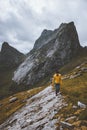 Man hiking alone in mountains Norway travel adventure active vacation