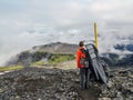 Man hiking alone into the wild admiring volcanic landscape with heavy backpack. Travel lifestyle adventure wanderlust concept Royalty Free Stock Photo