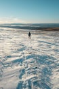 Man hiking in beautiful winter landscape snow view from mountain Litjskarven in Norway in sunnlight Royalty Free Stock Photo