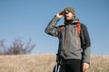Man with hiking equipment searching direction using binocular Royalty Free Stock Photo