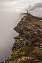 Hiking on famous Romsdalseggen Ridge in fog, Andalsnes, Norway