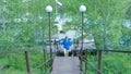 Man hiking in the forest as he climbs on the stair - travel and hiking. A man going up the stairs Royalty Free Stock Photo