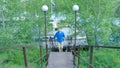 Man hiking in the forest as he climbs on the stair - travel and hiking. A man going up the stairs Royalty Free Stock Photo