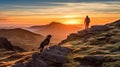 Man hiking on mountain as the sun rises with dog