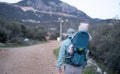 Man hiking in mountains,carrying baby in bacpack,sling,carrier.Family travelling,trips,lifestyle.Father,child,infant